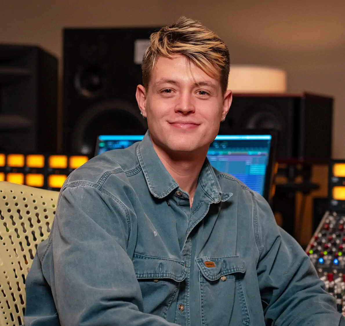 Jason Peets in a denim jacket smiling at the camera while.